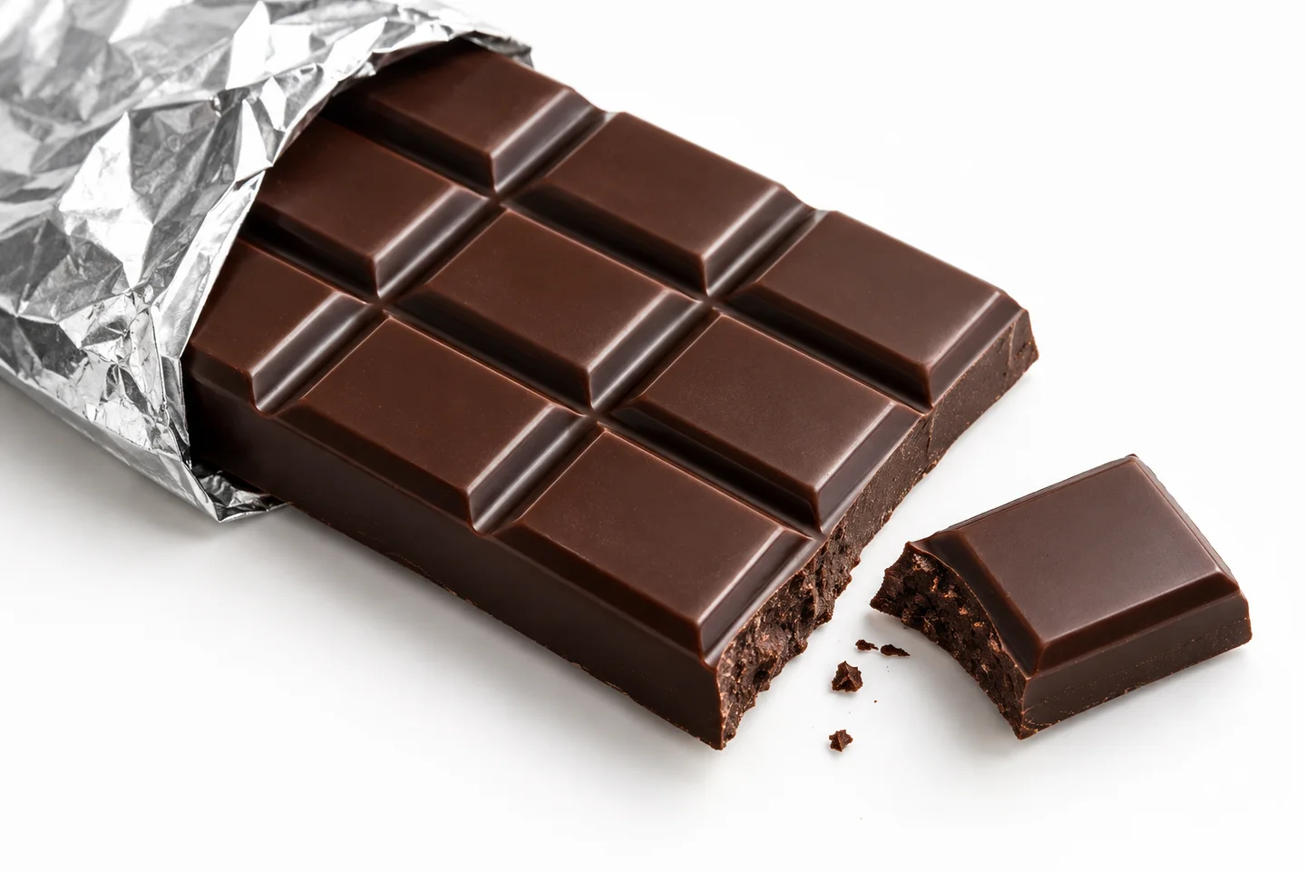 Glossy dark chocolate with a crisp broken edge and softly crumpled foil
